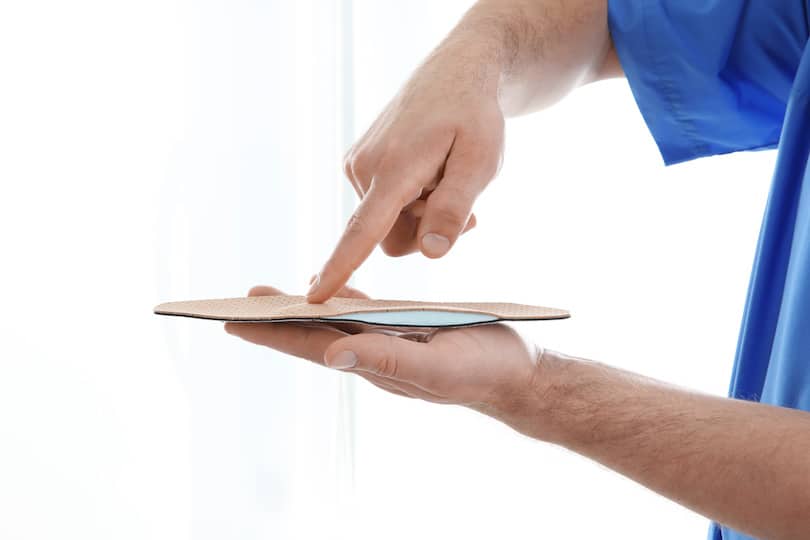 Male orthopedist with insole