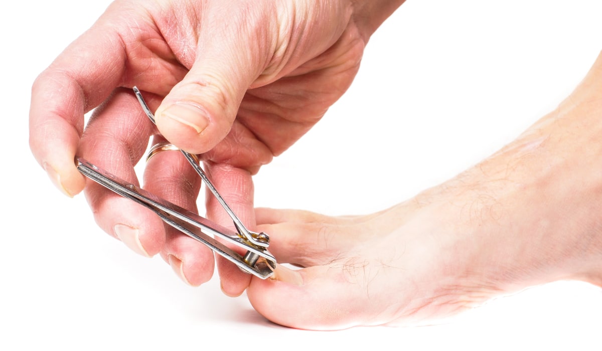 Person cutting ingrown big toe nail